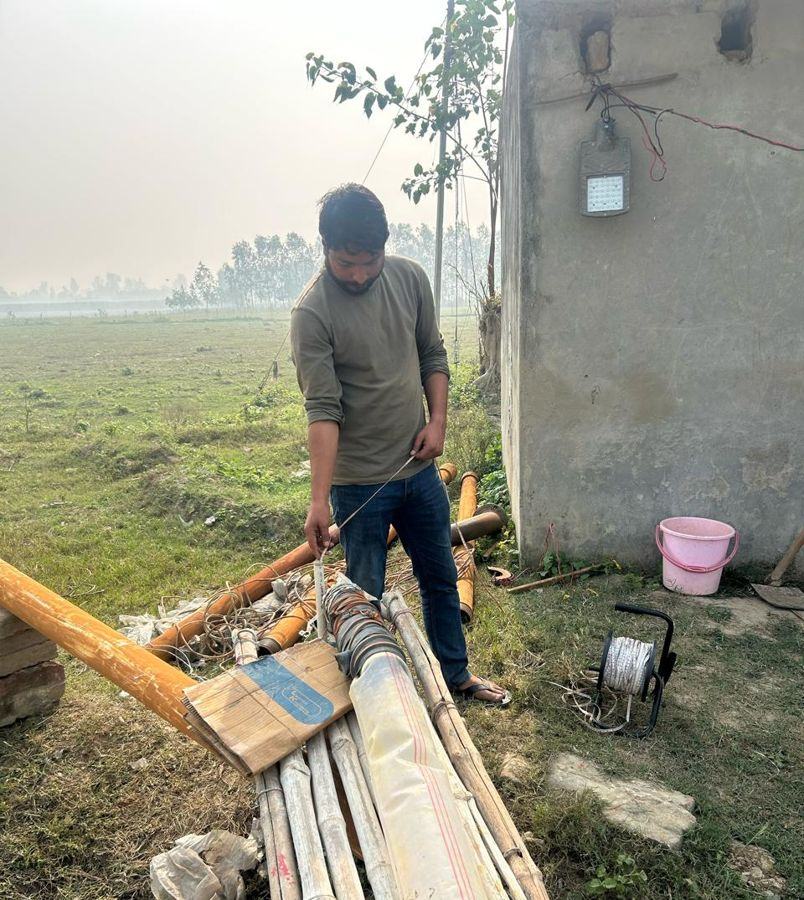 Hydrogeologist measuring water level in a pumping well