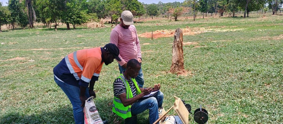Field team recording a resistivity sounding with the instrument on the ground